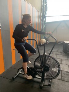 Elaine on assault bike in cardio tabata workout